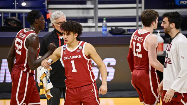Mar 22, 2021; Indianapolis, Indiana, USA; Oklahoma Sooners forward Jalen Hill (1) and forward Kur Kuath (52) react during a time out against the Gonzaga Bulldogs during the second half in the second round of the 2021 NCAA Tournament at Hinkle Fieldhouse. The Gonzaga Bulldogs won 87-71. Mandatory Credit: Marc Lebryk-USA TODAY Sports
